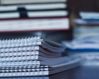 Accounting and taxes. Large pile of magazine, notebook and books closeup